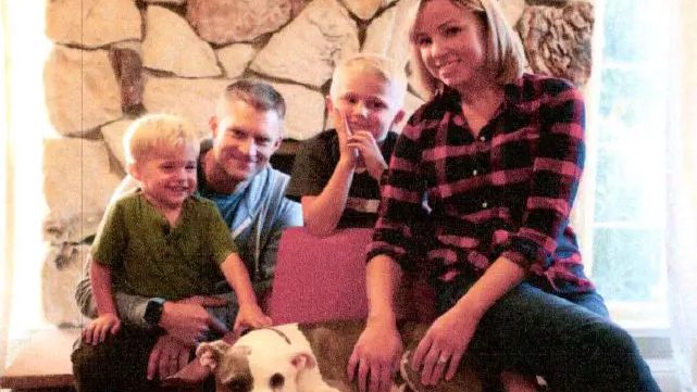 A family sitting together with their dog